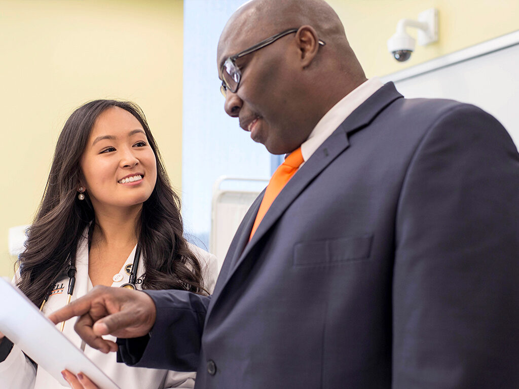 Image of student having conversation with professor in classroom