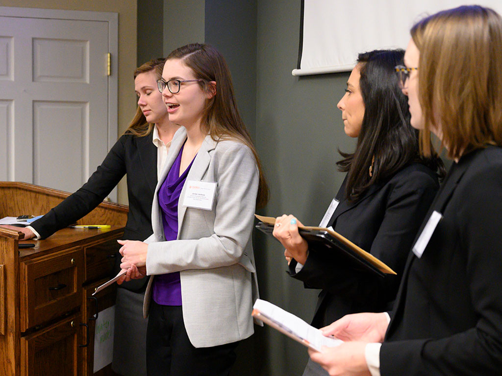 Image of a group of female students giving presentation