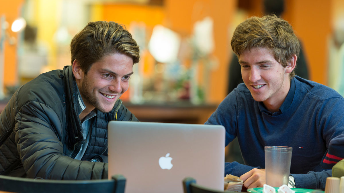 image of two students at computer