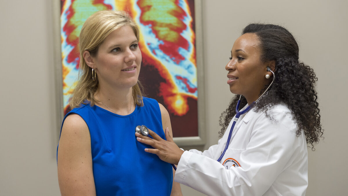 A young woman gets an exam by a Campbell student